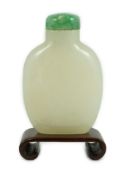 A Chinese white jade snuff bottle, 19th/20th century, of flattened high shouldered form, on an