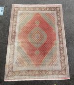 A Persian part silk Tabriz carpet, with central hexagonal motifs on a pink and cream ground, multi-