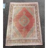 A Persian part silk Tabriz carpet, with central hexagonal motifs on a pink and cream ground, multi-