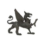 A 19th century bronze model of a griffon, standing with raised paw, length 58cm, height