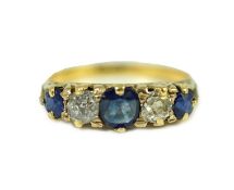 An 18ct gold, graduated three stone sapphire and two stone diamond set half hoop ring, with carved