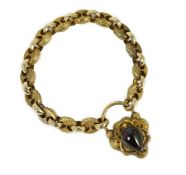 A Victorian engraved and facetted link mourning bracelet, with pear shaped foil backed? garnet set