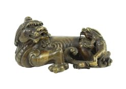 A finely cast Chinese bronze lion-dog and cub scroll weight, 17th/18th century, 14cm long, one