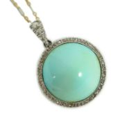 An early 20th century platinum and turquoise set pendant, with diamond chip border and diamond set