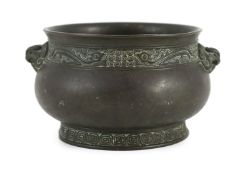 A Chinese archaistic bronze censer, gui, 17th/18th century, cast with a pair of mythical beast