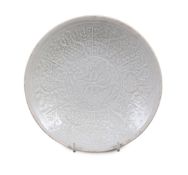 A Chinese Qingbai ‘Phoenix’ moulded dish, Yuan dynasty, the central medallion moulded with twin