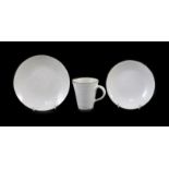 Dame Lucie Rie (1902-1995) a cup, saucer and side plate, c.1959, each white glazed stoneware with