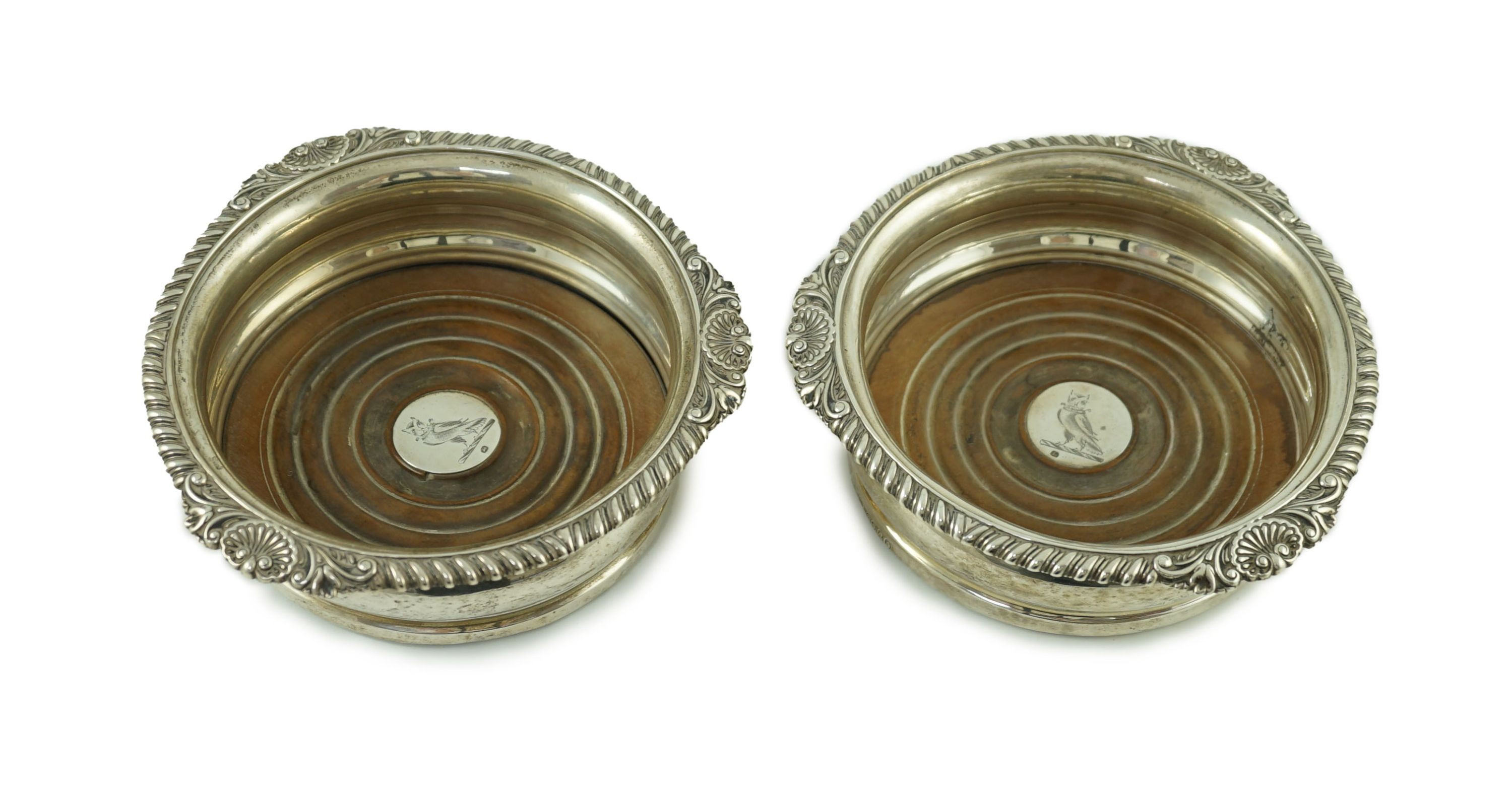 A pair of George IV silver wine coasters by Benjamin Smith III, with gadrooned and shell border, the