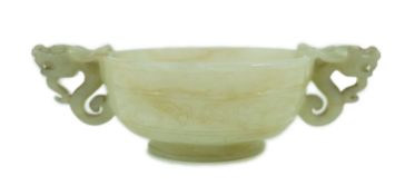 A Chinese pale celadon jade two handled ‘chilong’ cup, 17th/18th century, with a pair of carved