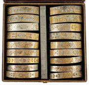 A Victorian cased travelling polychromatic metal bangle template set, containing eighteen numbered