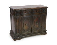 A 17th century Tuscan walnut credenza, the rectangular moulded top, over a pair of shaped oval