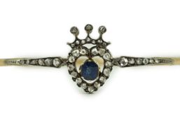 A 19th century gold, sapphire and rose cut diamond set hinged bangle, with central heart and coronet