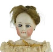 An S.G. bisque shoulder head French fashion doll c.1875, cork pate mohair wig attached, swivel neck,
