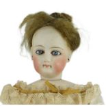 An S.G. bisque shoulder head French fashion doll c.1875, cork pate mohair wig attached, swivel neck,