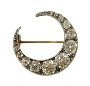 A Victorian gold, silver and graduated thirteen stone diamond set crescent brooch, the largest stone
