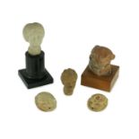 A group of antiquities comprising two commemorative scarabs, an Egyptian style gypsum head, and