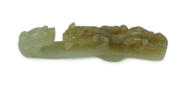A Chinese pale celadon and brown jade ‘dragon’ belt hook, 18th/19th century 10.7 cm longThe stone