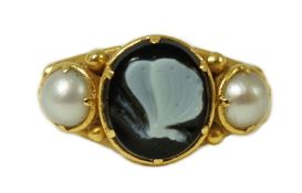 A William IV gold, split pearl and sardonyx set mourning ring, the oval hardstone carved with a