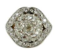 An early to mid 20th century continental gold and diamond set shaped circular cluster ring, set with