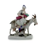 A Meissen group of the tailor’s wife riding a goat, 19th century, blue crossed swords mark and