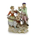 A Meissen Group of a young couple, Cupid and a hare, 19th century, blue crossed swords mark and