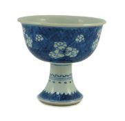 A Chinese blue white stem cup, Kangxi period, the bowl decorated with prunus blossom on cracked ice,