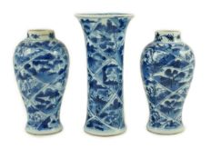A garniture of three Chinese blue and white vases, Kangxi period, each painted with landscape