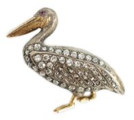 A Victorian style diamond encrusted and ruby set brooch, modelled as a pelican, with textured