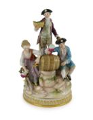 A Meissen group of the three winemakers, 19th century, after a model by Michel Victor Acier, blue