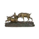 Thomas-Francois Cartier (1879-1943). A bronzed group of rutting stags, standing upon a