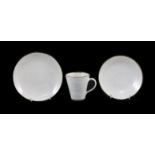 Dame Lucie Rie (1902-1995) a cup, saucer and side plate, c.1959, each white glazed stoneware with