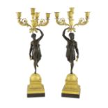 A pair of 19th century French Empire style bronze and ormolu four light candelabra, each modelled