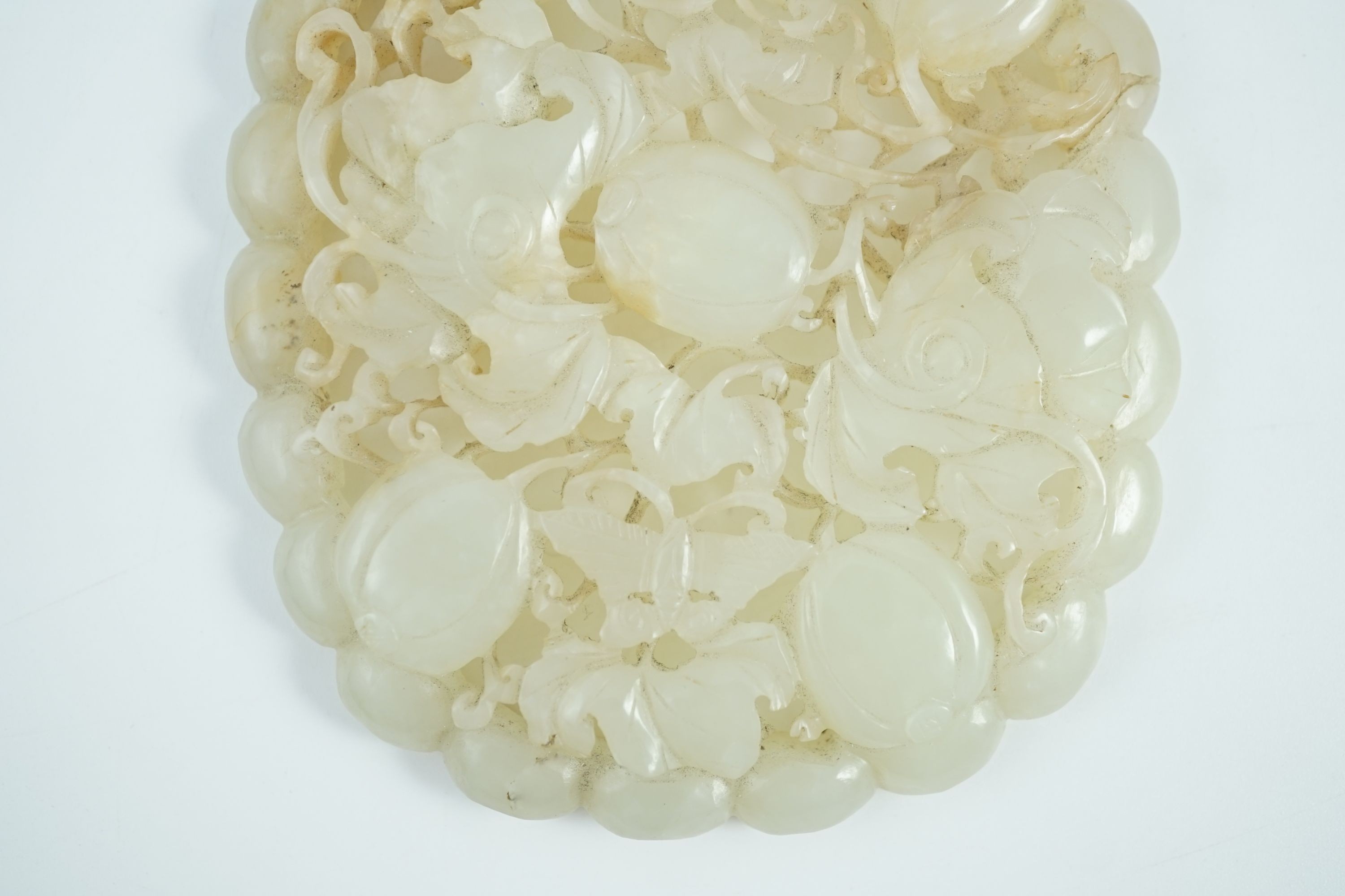 A Chinese pale celadon jade oval openwork plaque, 19th century, probably taken from a ruyi - Image 7 of 10