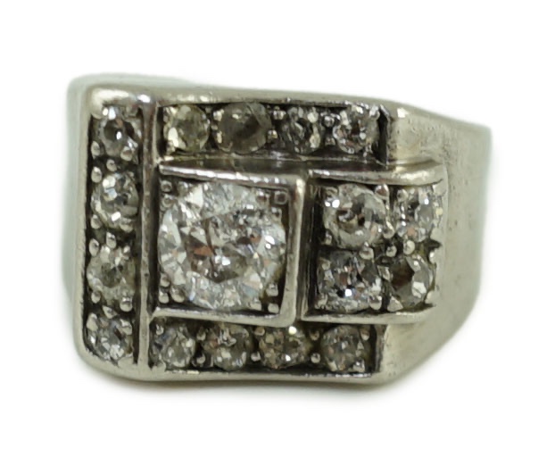 An Art Deco platinum? and diamond cluster set dress ring, the central stone weighing approximately