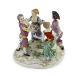 A Meissen group of four dancing children, early 20th century, blue crossed swords mark and incised