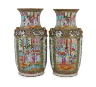 A pair of Chinese famille rose vases, 19th century, typically painted with figures amid pavilions