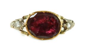 A George III gold, foil backed garnet and rose cut diamond set three stone ring, with pierced