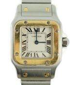 A lady's steel and gold Santos De Cartier quartz wrist watch, with Roman dial and cabochon set