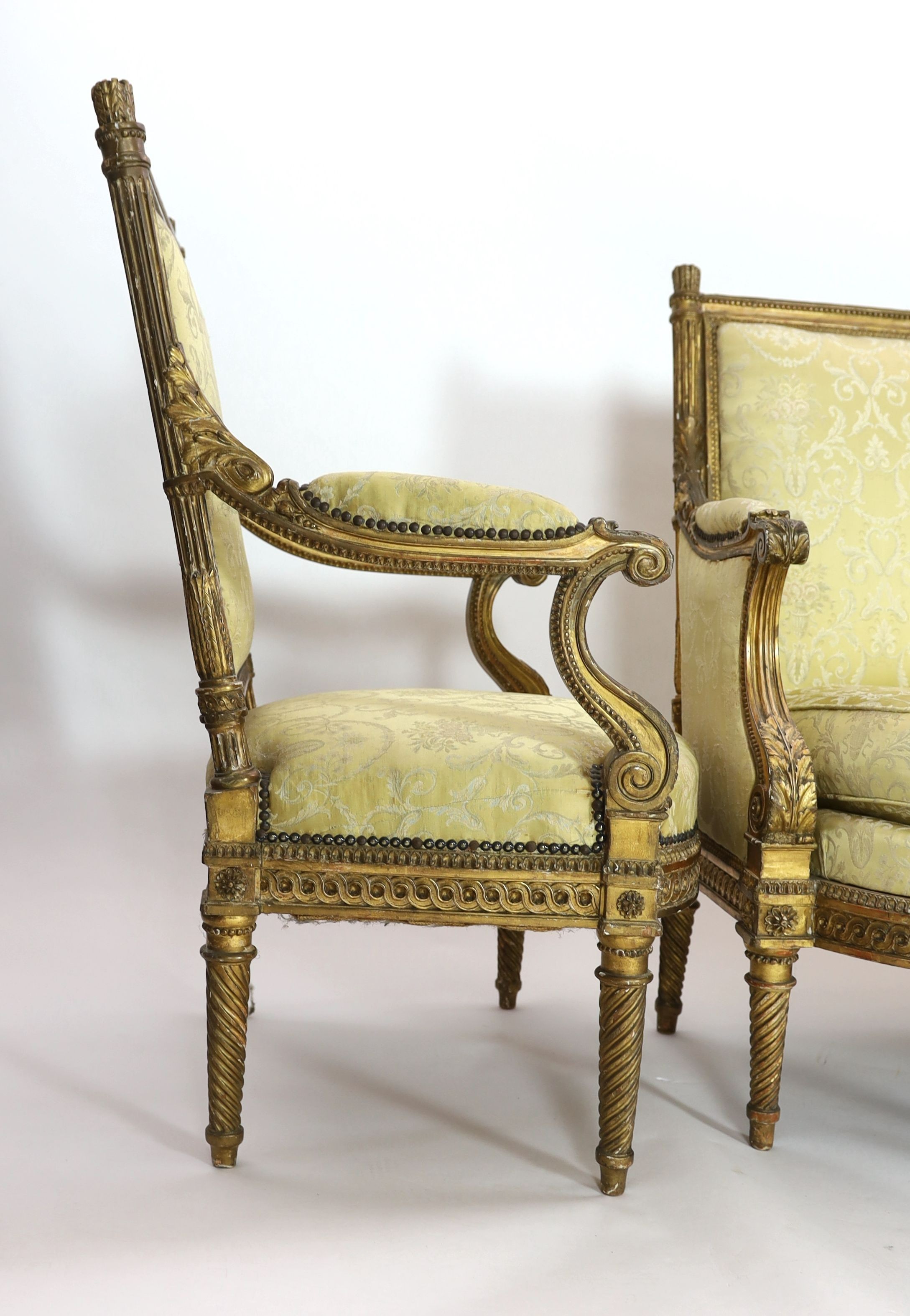 A Louis XVI carved giltwood five piece salon suite, comprising settee, pair of armchairs and pair of - Image 4 of 5