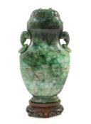 A Chinese archaistic green jadeite vase and cover, late Qing dynasty, with a pair of elephant head