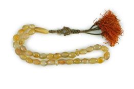 A Sino-Tibetan row of agate prayer beads, 19th century Total drop including tassel 36 cmThe beads