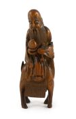 A Chinese bamboo group of Shou Lao riding a deer, 18th/19th century, caramel brown patina, the