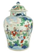 A Chinese Transitional wucai 'boys' vase and cover, c.1640, painted with ladies watching over boys