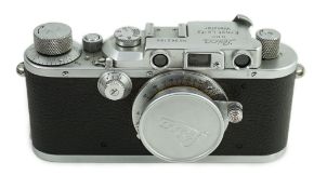 A Leica IIIa camera, number 302196 with Leitz Elmar F51:35 lens, Elmar 5cm adapter ring and