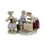 A Meissen group of two children eating from a bowl, dot period and a Meissen figure of a flower