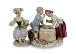 A Meissen group of two children eating from a bowl, dot period and a Meissen figure of a flower