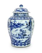A large Chinese blue and white jar and cover, Kangxi period, painted with alternating landscape