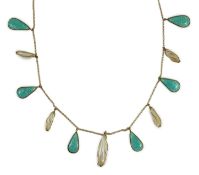 An early 20th century gold, enamel and baroque pearl set drop fringe necklace, in the manner of