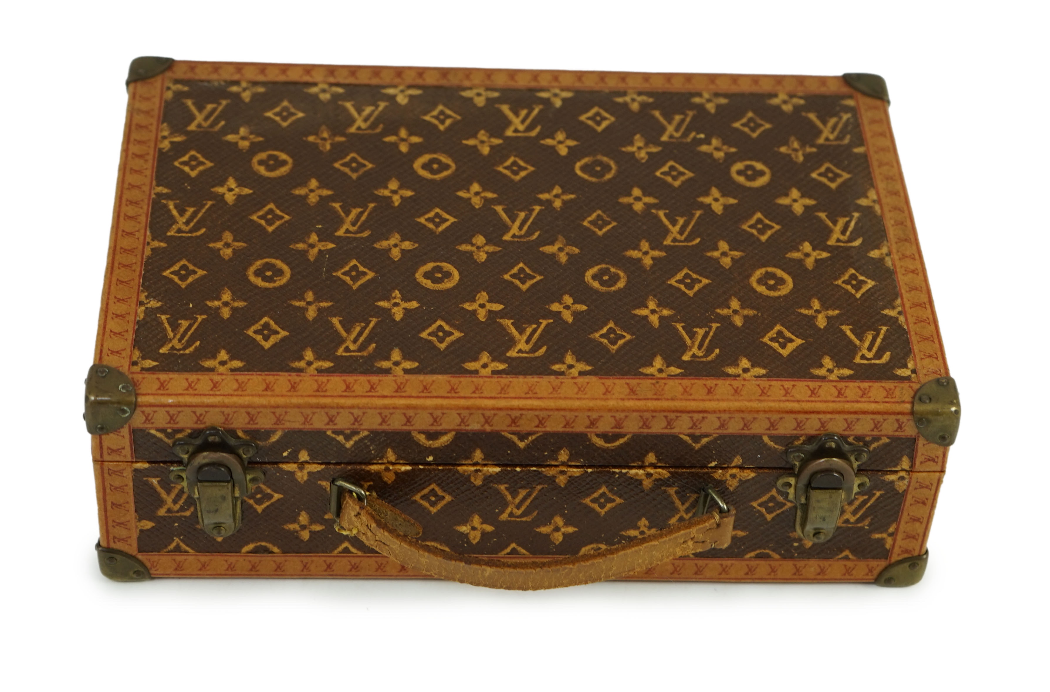 A 1920’s Louis Vuitton miniature suitcase, stamped L.Vuitton, 20 x 13 x 6cm.Overall of good original