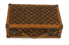 A 1920’s Louis Vuitton miniature suitcase, stamped L.Vuitton, 20 x 13 x 6cm.Overall of good original